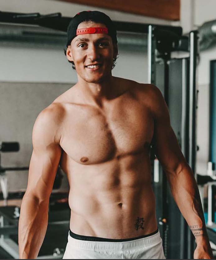 Yul posing for the transformation section with a gym background